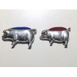 A silver pig pin cushion, London 1954, 1.8" across and a 925 pig pin cushion. (2)