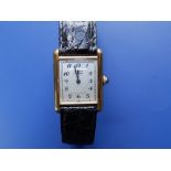 A boxed lady's gold plated Must De Cartier Tank Quartz wrist watch with sapphire cabochon to