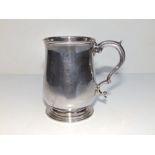 A George III silver mug, the plain tulip body with double-curve handle, TW, London 1778, 3.8" high.