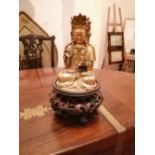 A gilt bronze Buddha on rosewood stand, 9" high.