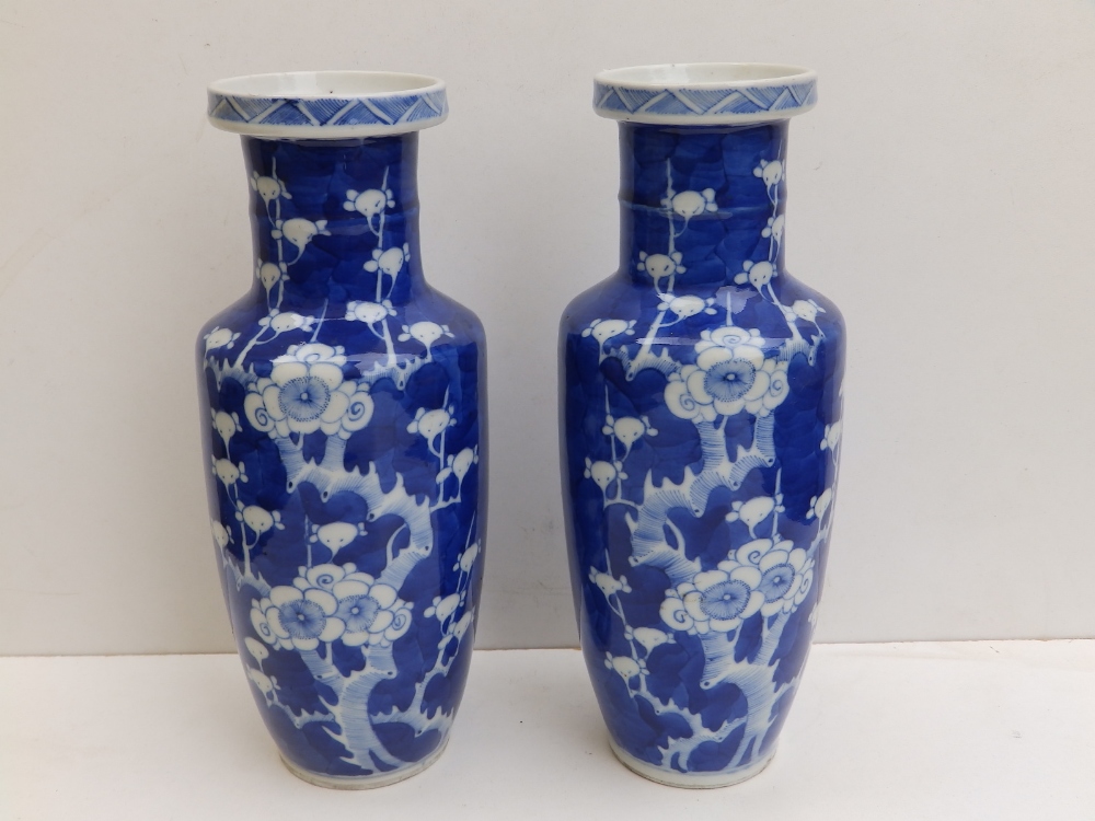 A pair of Chinese blue & white porcelain hawthorn pattern rouleau shaped vases - bearing six