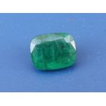 An unmounted cushion cut emerald weighing approximately 1.8 carats, measuring approximately 9 x 7.