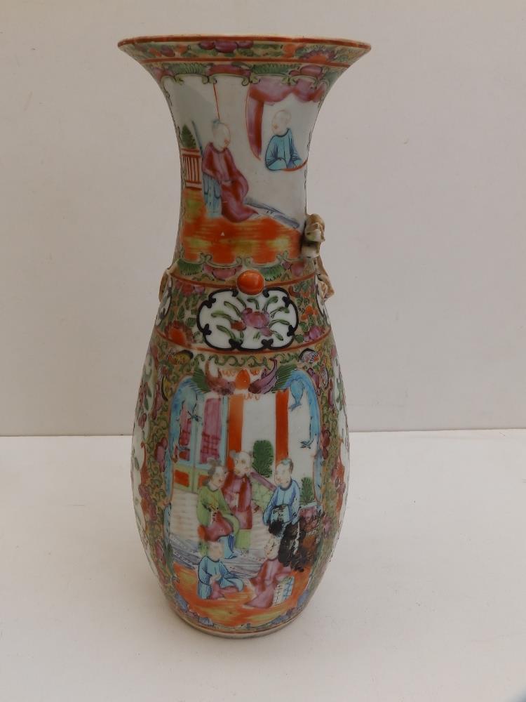 A 19thC Cantonese porcelain vase of slender baulster form with applied dragon to shoulders, 10"