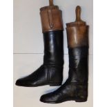A large pair of knee-length leather boots. (2)