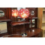 Decorative table lamp with red glass shade,