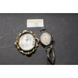 19th century Pinchbeck framed shell cameo and a white metal 1930's cocktail watch