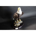 Moulded resin figure of a golden eagle on plinth