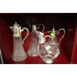 Four cut glass claret jugs with silver plated necks and lids and a Royal Crystal Rock claret jug