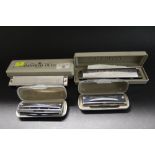 Four Suzuki harmonicas (cased)