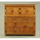 A Brewer & Company oak court cupboard, circa 1970, of typical form with cupboards and drawers.