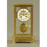 An Edwardian brass library clock, with visible Brocot escapement and large pendulum.