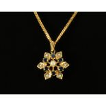 A 9 ct gold seed pearl and sapphire set star pendant on 9 ct gold chain. Gross weight 5.