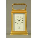 A brass carriage clock, with repeat mechanism and alarm. Height excluding carrying handle 14 cm.