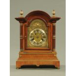 An Edwardian walnut and brass mounted mantle clock, with two train spring driven movement.