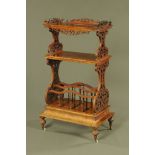 A Victorian figured walnut three tier whatnot, with shaped pierced gallery,