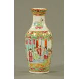 A Chinese Cantonese vase, decorated with figures in typical Canton colours. Height 16 cm.