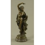 A bronze figure of a draped female, green patination raised on a marble plinth.