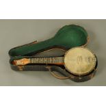 A vintage John Grey & Son of London banjo, cased. Length 55 cm.