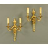 A pair of Adam style metal two branch wall sconces. Height 40 cm.