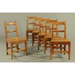A set of six early 19th century country oak dining chairs,
