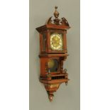 An Edwardian carved walnut wall clock,