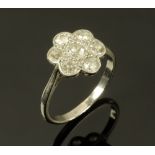 A white gold coloured metal diamond set daisy cluster ring. Size M.
