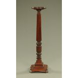 A mahogany bed post torchere, with circular top and stepped base.