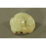 A jade Netsuke depicting a sleeping Dog of Fo. Length 44 mm.