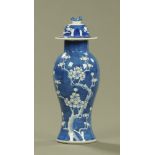 A Chinese baluster lidded vase, prunus pattern and with concentric ring marks to the base.