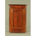 A George III oak and mahogany corner cupboard,