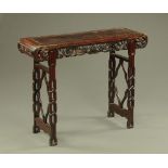 A Chinese hardwood altar table, with carved and pierced frieze and similar supports.