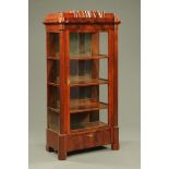 A 19th century Biedermeier figured mahogany display cabinet, with stepped top,