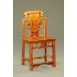 A 19th century Chinese stained wooden chair, with splat back and solid seat.