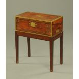 An early 19th century mahogany brass bound and strung table desk, raised on a later stand.