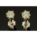 A pair of 18 ct white gold diamond stud earrings, with diamonds weighing +/- .63 carats.