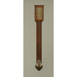 A George III mahogany stick barometer, with paper label, exposed tube and turned cistern cover.