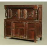 A 17th century oak court cupboard, with carved frieze,