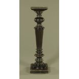 A Victorian ebonised wood torchere, with square top and base, fluted and reeded column.