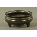 A 19th century Chinese bronze circular stand, raised on three short feet, character mark to base.