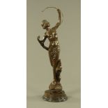 A large green patinated bronze figure of Diana with dog at foot, and raised on a marble plinth.