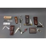 Seven folding pocket knives, to include a Victorinox, Victoria Officer knife with horn scales,