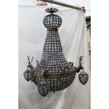 A ceiling hanging chandelier, decorated with four stags heads. Width +/- 50 cm, height +/- 90 cm.