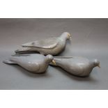 Two early to mid 20th century wooden pigeon decoys (later repainted), together with a plastic decoy.