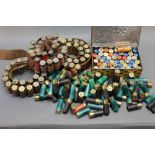 Approximately 230 - 12 bore shotgun cartridges, paper and plastic cases, and three cartridge belts.