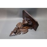 A 20th century oak wall bracket with carved deer's head, length 40 cm, width 35 cm, depth 23 cm.