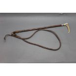 A ladies or child's riding whip, having a stag antler handle with silver coloured collar,