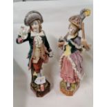 A pair of continental porcelain figural ornaments of lady and gentleman