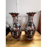 A pair of oriental polychrome vases on blue ground, decorated with mountain scenes and peonies,