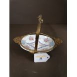 A continental porcelain basket in a gilt metal mount