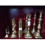 Four pairs of brass candlesticks and two trench art vases